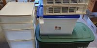 Group shot of all storage items: drawer organizer, green tote, latching bin, stacking crate