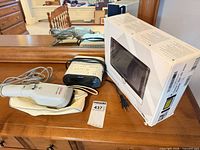 Sunbeam steamer, Sony clock radio, boxed Visolux HD magnifier on dresser