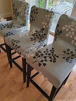 Three upholstered bar stools in a row