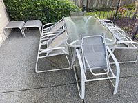 overall view of table, six chairs, two ottomans