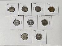 Eight coins in holders, two rows