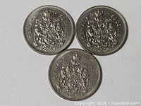 Front view of all three coins showing reverse side with dates