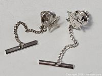 Full view of both maple leaf tie pins showing chains and T-bars