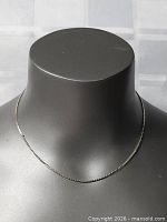 Full view of sterling silver necklace on display bust