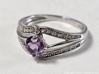Full view of sterling silver ring with amethyst center stone