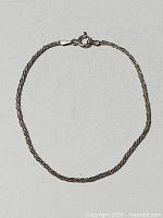 Full view of sterling silver rope chain bracelet with clasp