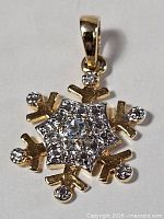 Front view of snowflake pendant showing crystal settings and bail