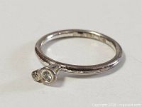 Full view of sterling silver ring showing twin bezel-set stones