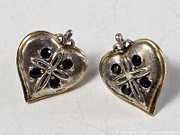 Front view of both heart-shaped sterling earrings showing stones and gilt rim