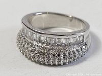 full view of sterling silver ring showing crystal encrusted dome and channel set baguette stones