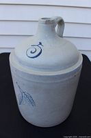 Full view of cream stoneware beehive jug showing handle and body