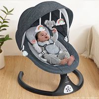 Marketing image of assembled grey Caveen baby rocker showing design details