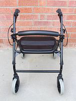 Front view of black Built Swift Lite rollator showing seat, backrest, wheels and brakes