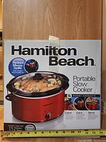 Front of sealed retail box showing Hamilton Beach portable slow cooker, model 33155, 5-quart capacity