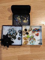 Overall view of three jewelry boxes with assorted items