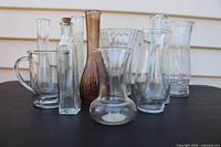 All ten glass vases grouped together showing variety of shapes, colors and sizes