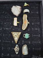 Nine rings laid out in display case showing overall contents