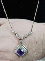 Necklace on wrist showing pendant detail