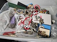 Overview of tote filled with assorted jewelry pieces and boxes