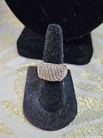 Front view of Judith Ripka sterling silver ring showing rope-textured panel