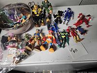Overview of figures, bowl of small toys, bag of parts