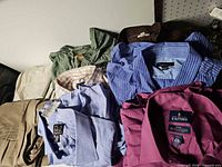 Overview of folded shirts showing labels Jos. A. Bank, Stafford, Stafford purple