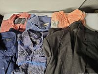 Six garments laid flat displaying colors and patterns