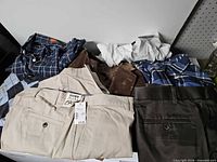 Assorted pants, shirts and shorts laid out