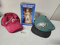 Front view of lot showing bobblehead box and two caps