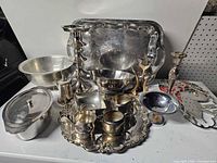 Overall view of all metal serving pieces and candlesticks
