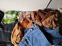 Pile of seven assorted garments laid out