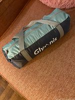 Zippered Glymnis carry bag showing branding and handles
