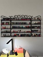 Full view of 3-piece nail polish rack mounted on wall holding bottles