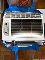 Front view of NOMA window air conditioner showing control panel and vent grille