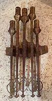Front view of five-candle wrought iron wall sconce showing full design and patina finish