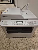 Front view of Brother MFC-7360N printer showing control panel and paper tray