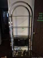 Front view showing full height chrome frame and five glass shelves