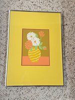 Full view of framed serigraph showing yellow mat and silver frame