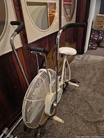 Full side view of Johnson exercise bike showing fan wheel, frame, handlebars, seat