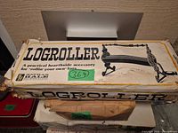 Front of damaged box showing Logroller branding and illustration