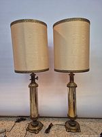 Front view of both brass table lamps with shades