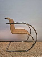 Side profile showing cantilever chrome frame and rattan seat