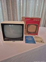 Front view of Emerson BCR128 CRT television with box and manuals