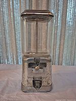 Front view of chrome and glass Oak gumball machine