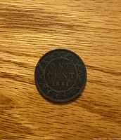 Reverse side showing ONE CENT 1881 with vine border