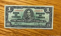 Front of 1937 Bank of Canada $1 note showing serial 3945679, King George VI portrait, signatures