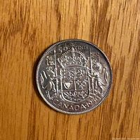 Reverse side showing coat of arms, denomination, country and date