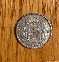 Reverse view showing Canadian coat of arms and date 1958