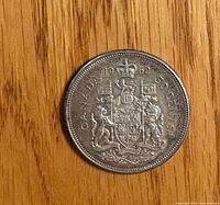 Reverse: Canadian coat of arms, date 1962 visible