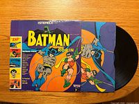 Front sleeve of Batman and Robin LP with vinyl partially removed, showing artwork and track list sidebar
